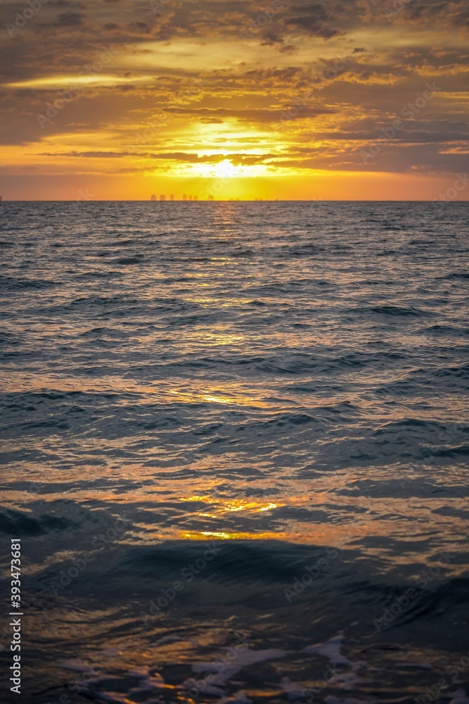 Brilliant sunset over the ocean waves reflecting on the water at Sanibel Beach in Florida before Hurricane Ian