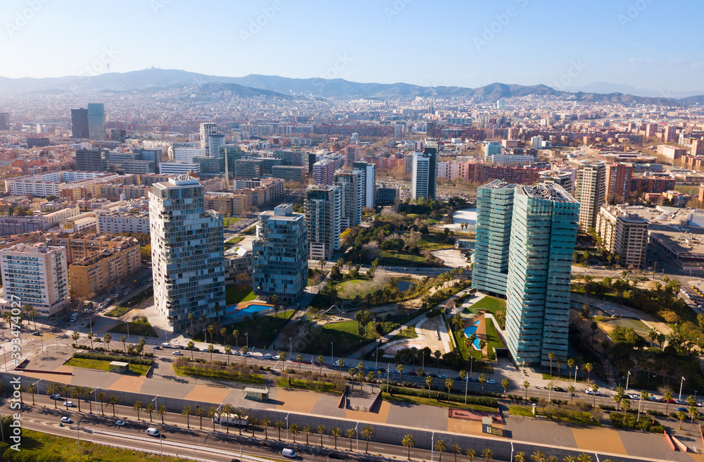 Aerial view of new residential complex of Diagonal Mar i el Front Maritim del Poblenou in sunny day, Barcelona, Spain..