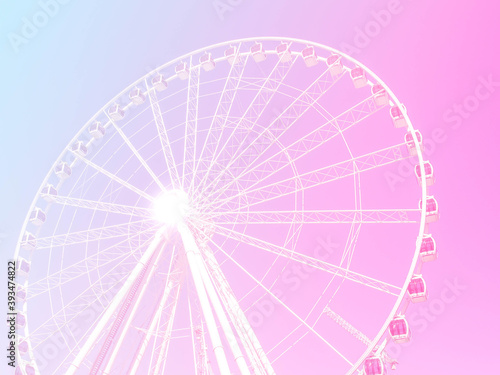 ferris wheel on pink and blue sky background