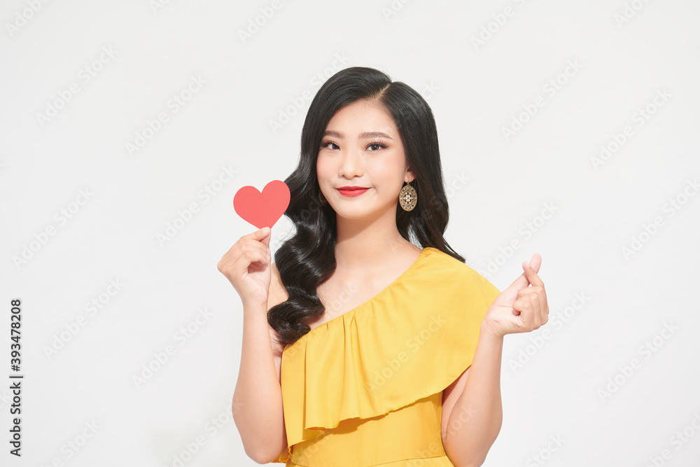 Portrait of attractive, pretty lady look at camera make hold paper red heart in hands isolated on shine teal background Portrait of attractive, pretty lady look at camera make hold paper red heart in hands isolated on shine teal background