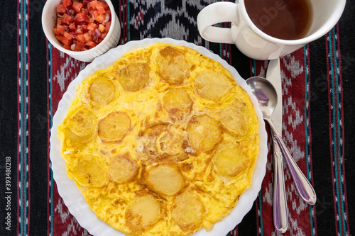 Traditional East African breakfast of Chips Mayai, a fried potato omelet, Arusha, Tanzania
 photo