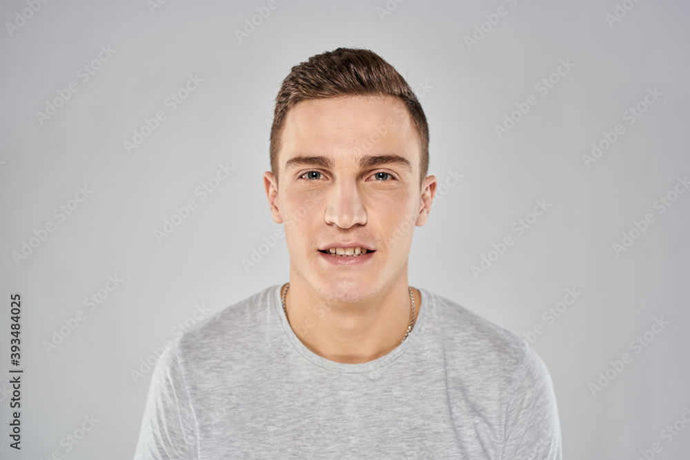 handsome man in light t-shirt cropped view emotion studio isolated background handsome man in light t-shirt cropped view emotion studio isolated background