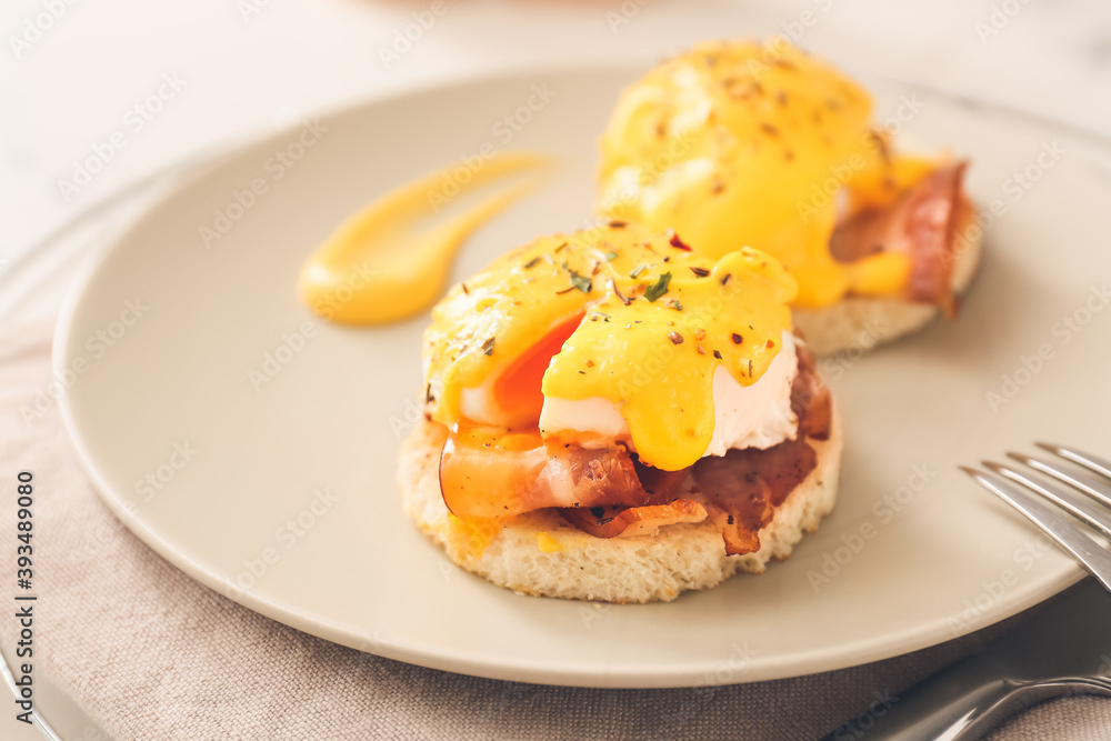 Plate with tasty eggs Benedict on table, closeup Plate with tasty eggs Benedict on table, closeup