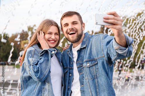 Young couple taking selfie ...
