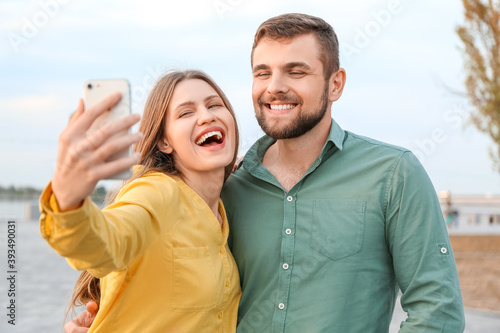 Young couple taking selfie ...