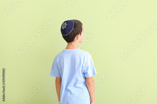 Cute Jewish boy on color ba...