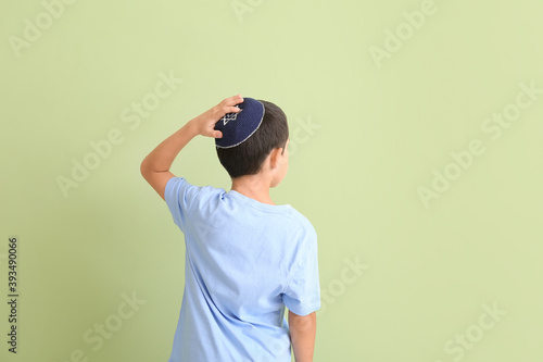 Cute Jewish boy on color ba...