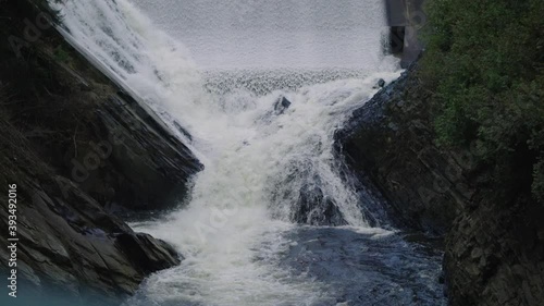 Strong Flowing Stream Down Into Rocks Covered With Moss In Coaticook River Valley, Quebec Canada, Slow Motion photo