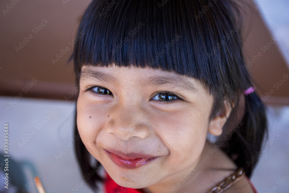 The cute little Asian girl is happily eating ice cream. The cute little Asian girl is happily eating ice cream.