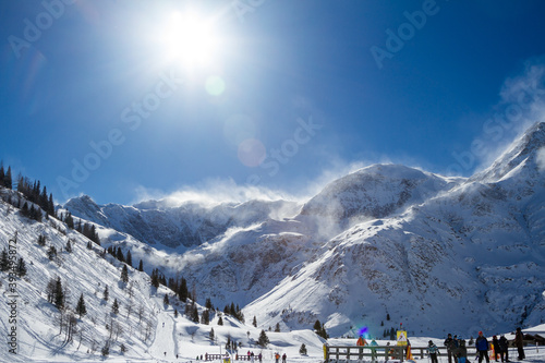 Winter landscape with panorama views of the Alps in the winter sports region Bad Gastein, Austrian Alps. Snowstorm on a sunny day