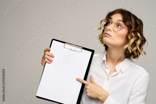 Business woman with folder of documents in hands on gray background cropped view of work