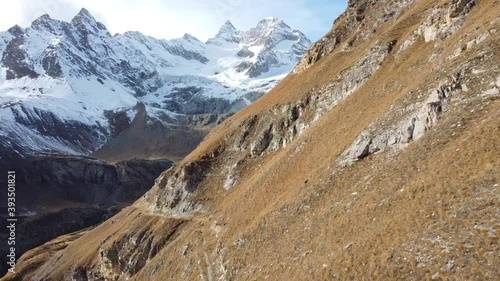 Close-to-flight on green, steep meadows to a snow-covered mountain range in the swiss alps, amazing scenery (Gabelhorn) photo