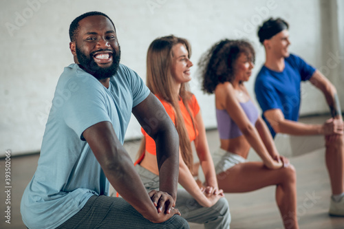 Dancers feeling good while doing stretching exercises