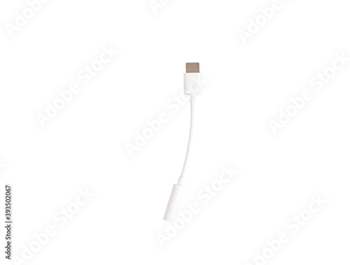 Adapter for a USB - 3.5 mm type c headphone cable on a smartphone. Close-up of a white 3.5 mm audio cable on a white isolated background. Copy space. The view from the top
