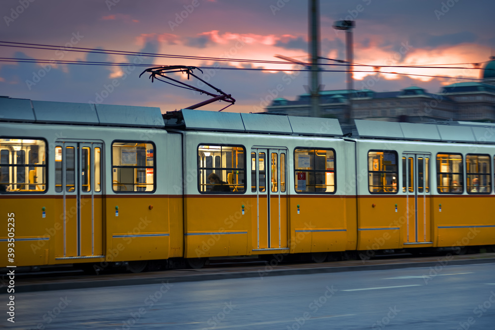 Naklejka premium Long old tram in the city street