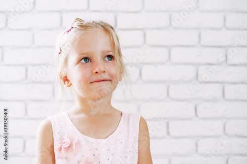 Portrait of a little cute girl in pink dress