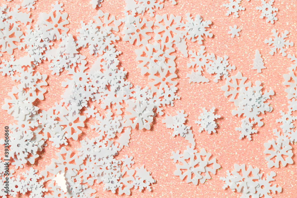 Light pink background with snow glitter and sequins. Flat lay style. Winter soft texture with snowflakes for creating projects and designs Light pink background with snow glitter and sequins. Flat lay style. Winter soft texture with snowflakes for creating projects and designs