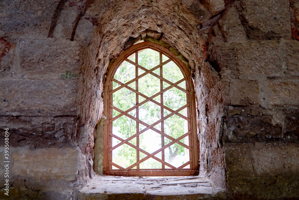 Fototapeta premium antique castle window bathed in sunlight