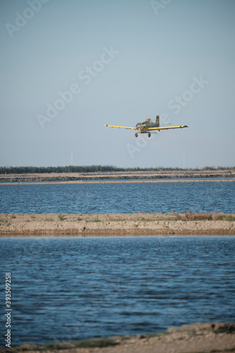 Plane sowing rice in the waterlogged field.