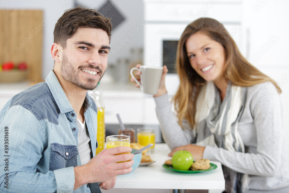 young couple making breakfast and having fun young couple making breakfast and having fun