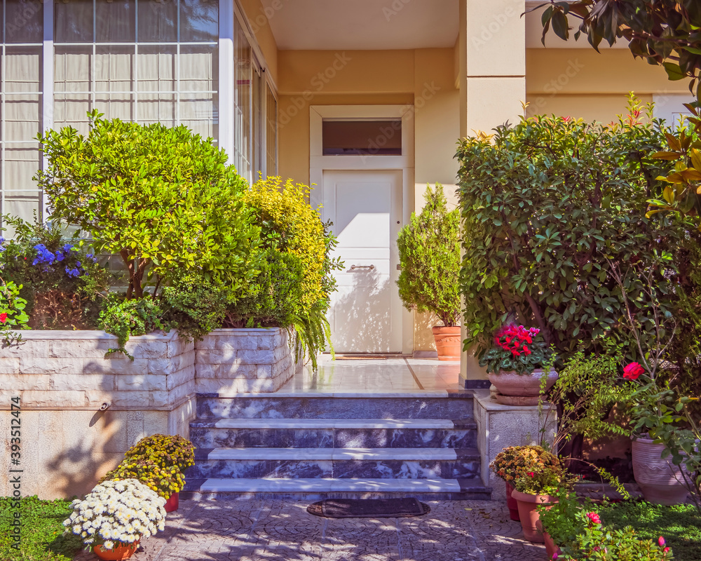 stylish family house front corridor through the garden to the main entrance door stylish family house front corridor through the garden to the main entrance door