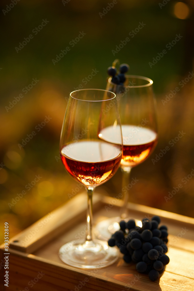 Two glasses of rose wine on a wooden crate, top view