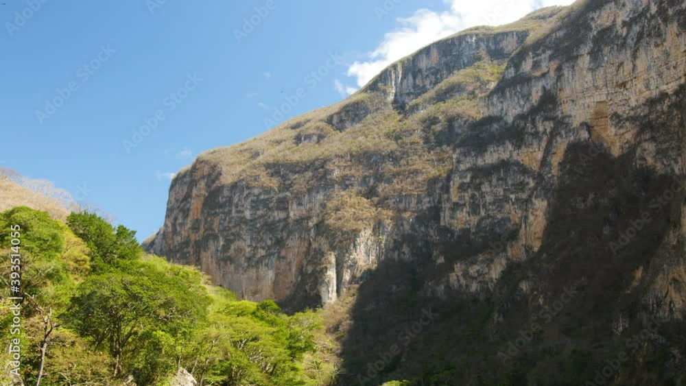 Beautiful steep rock formation in Sumidero Canyon Park during blue sky and green trees.Chiapas,Mexico. Beautiful steep rock formation in Sumidero Canyon Park during blue sky and green trees.Chiapas,Mexico.