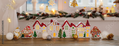 Christmas toy houses on  background of  decorated window