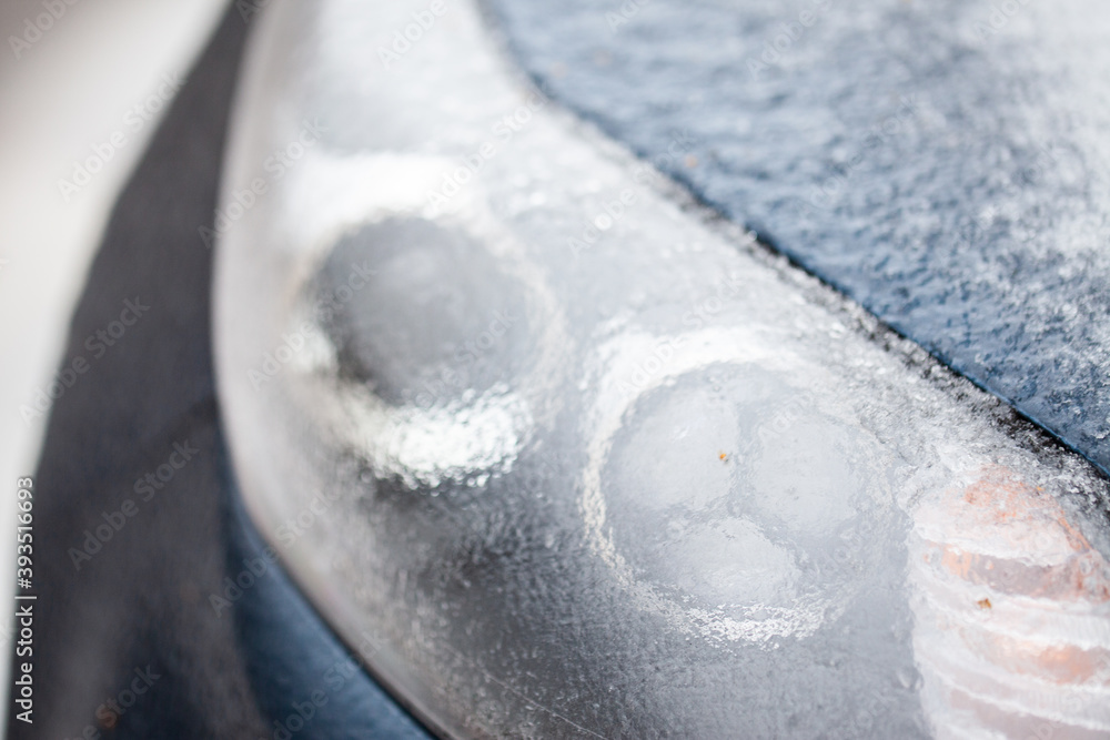 Ice crust on the car headlight after ice rain. Ice crust on the car headlight after ice rain.