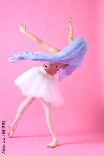 Graceful ballet dancer or classic ballerina dancing isolated on grey studio background. Woman with the pink scarf.