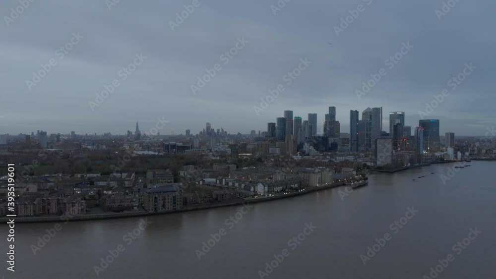 Wide falling drone shot of London skyline from Canary wharf cloudy Wide falling drone shot of London skyline from Canary wharf cloudy