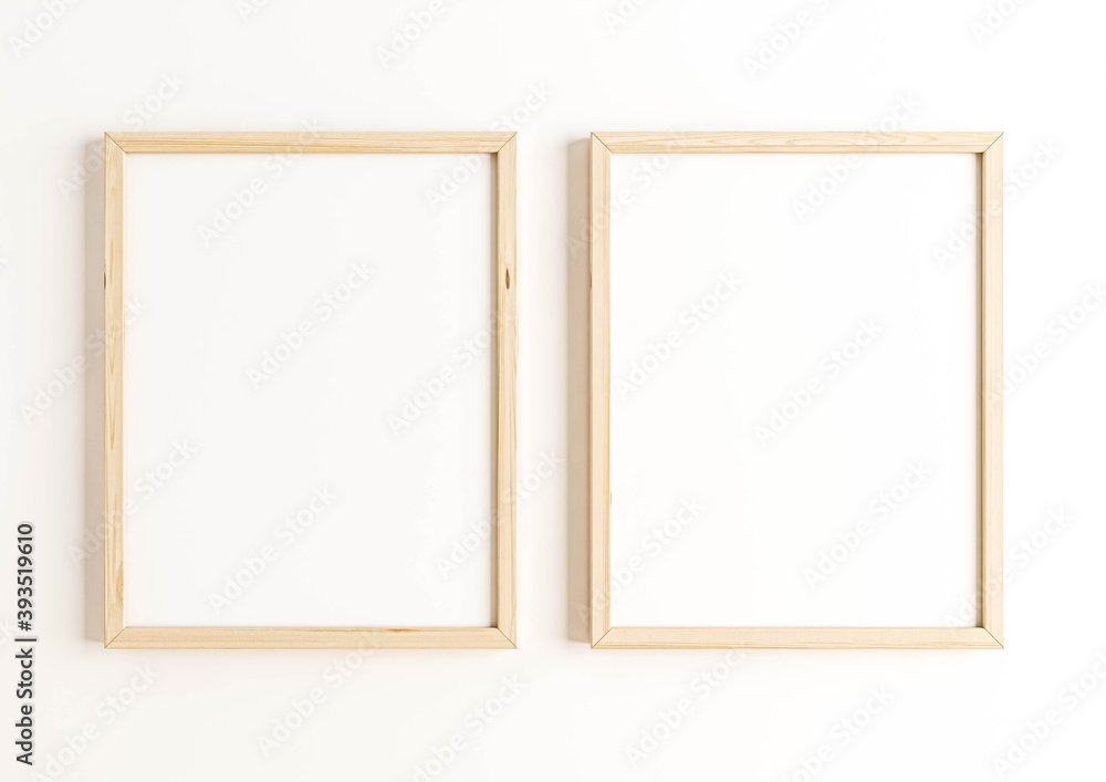 Two Vertical 8x10 Wood Frames Mockup. Double Vertical Wood Frames on a white wall. Two Vertical 8x10 Wood Frames Mockup. Double Vertical Wood Frames on a white wall.