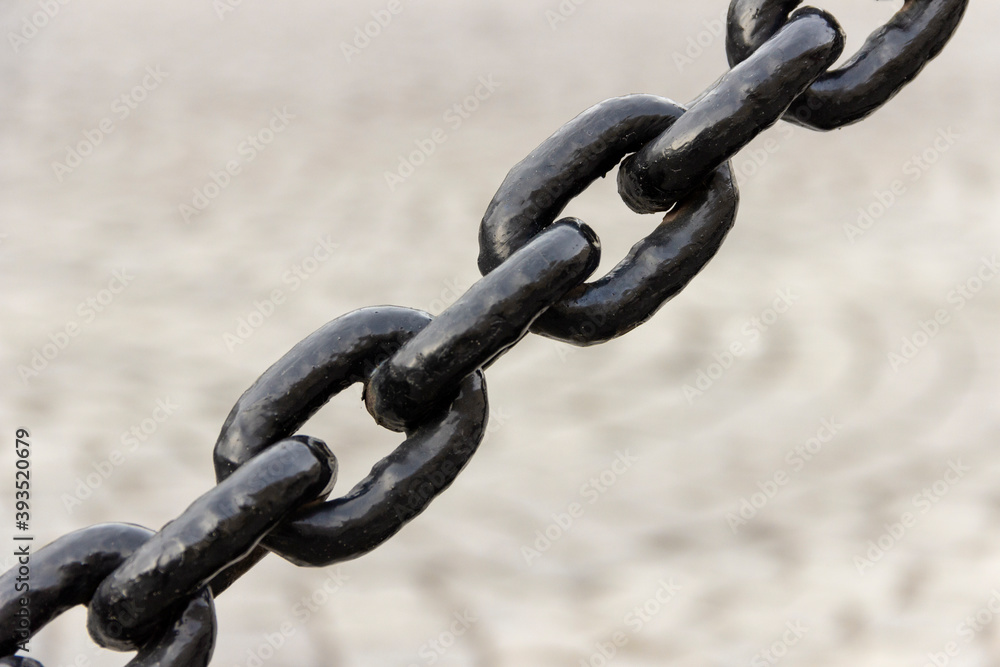 Black painted metal chain in a fence. Black painted metal chain in a fence.