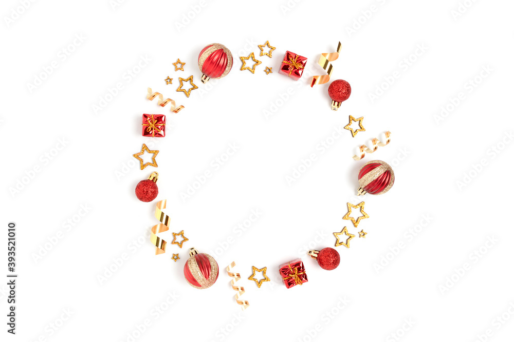 Wreath made of red Christmas toys and gold confetti. Minimalist festive frame on a white background.