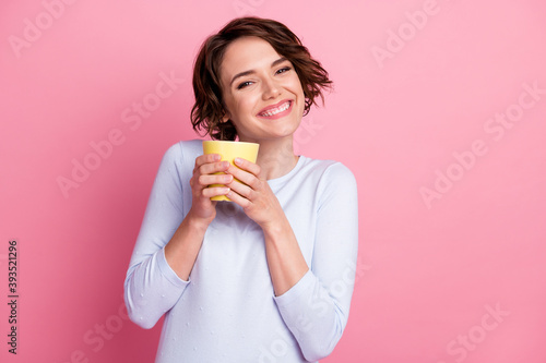 Portrait of lovely girl hold hot caffeine latte beverage mug wear pullover isolated over pastel color background