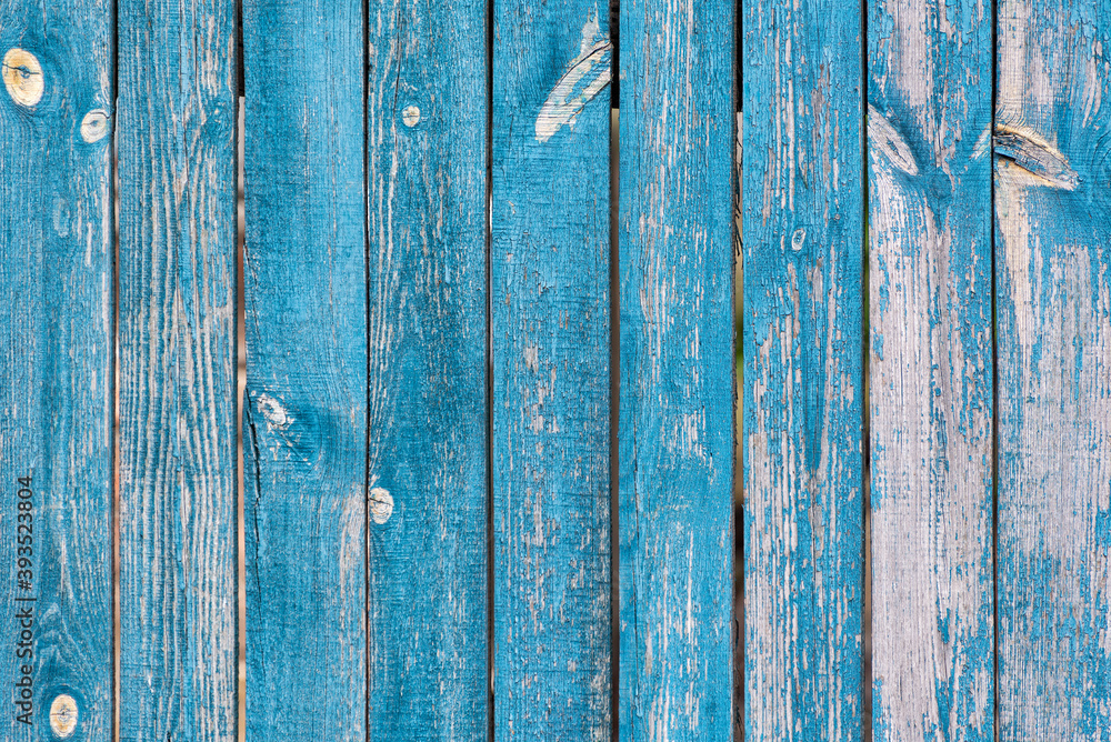 Old blue boards with cracked paint. Old wooden fence. Abstract background Old blue boards with cracked paint. Old wooden fence. Abstract background