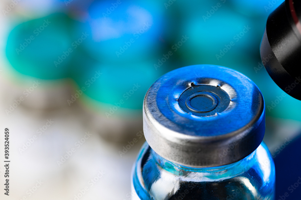 Medical vial with medication near microscope photo Medical vial with medication near microscope photo