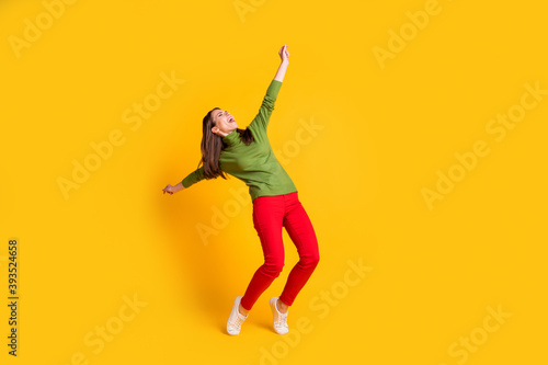 Full length body size view of attractive overjoyed cheerful girl jumping dancing having fun isolated bright yellow color background