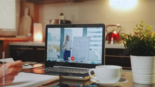 Wallpaper Mural Online video conference on laptop with business woman speaker in home office. In the foreground: writing hands and a cup. Torontodigital.ca