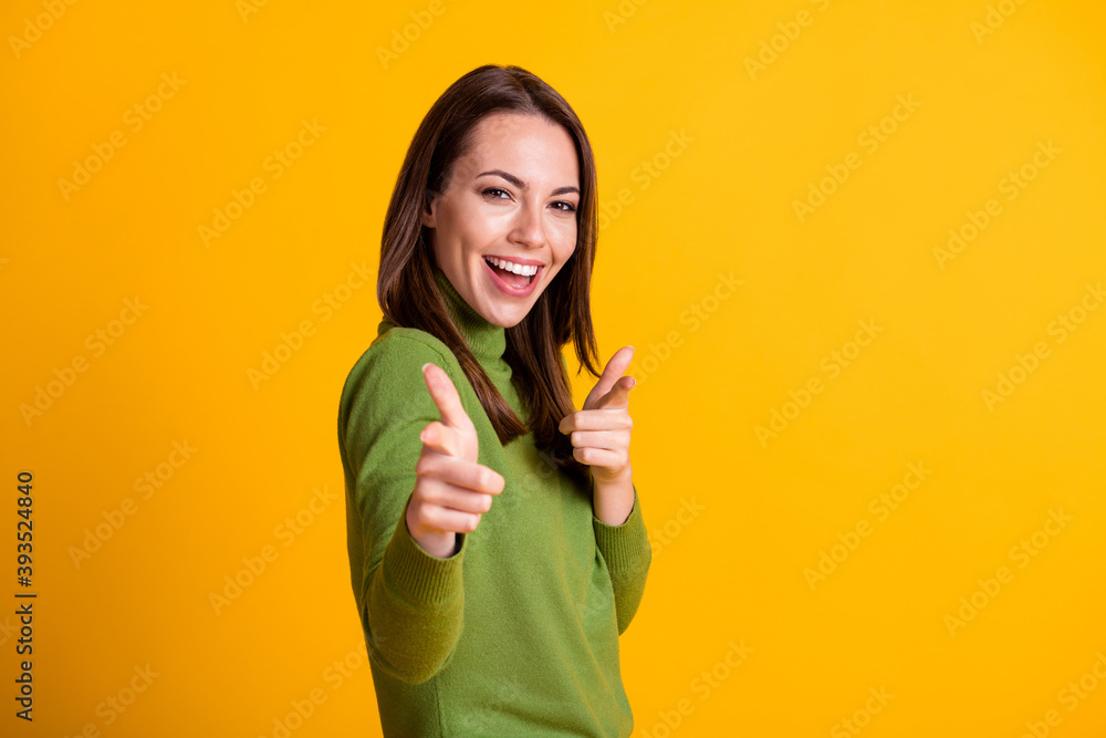 Photo of attractive lady directing fingers straight on camera wear green sweater isolated yellow color background Photo of attractive lady directing fingers straight on camera wear green sweater isolated yellow color background