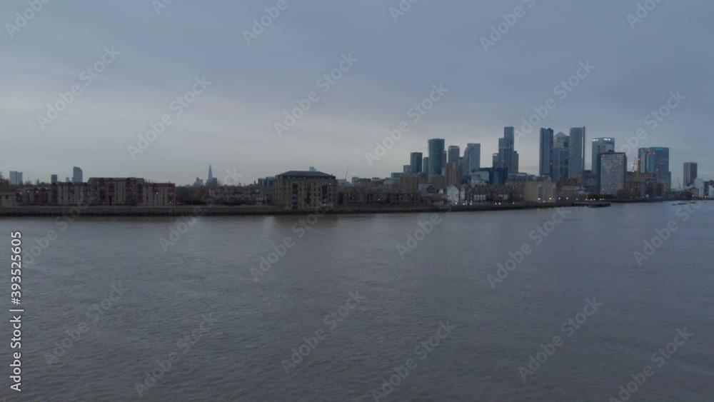 Rising drone shot of canary wharf Isle of dogs London in the evening Rising drone shot of canary wharf Isle of dogs London in the evening