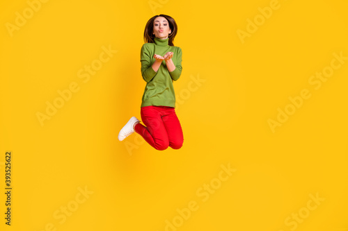 Full body photo of pretty lady jump high up send air kisses open palms isolated yellow bright color background