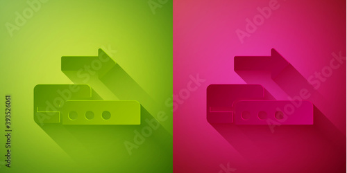 Paper cut Pos terminal with inserted credit card icon isolated on green and pink background. Payment terminal transaction. Pay by card. Paper art style. Vector.