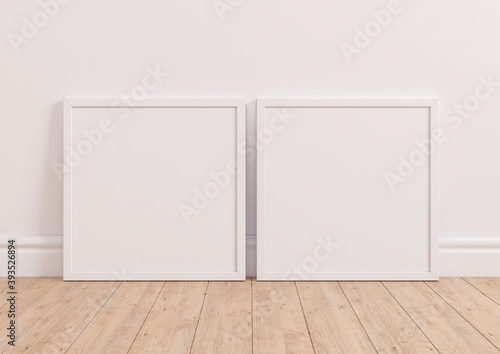 Two Interior frame mockups with square white frame on  wooden floor. White frame poster on white background. 3D rendering.