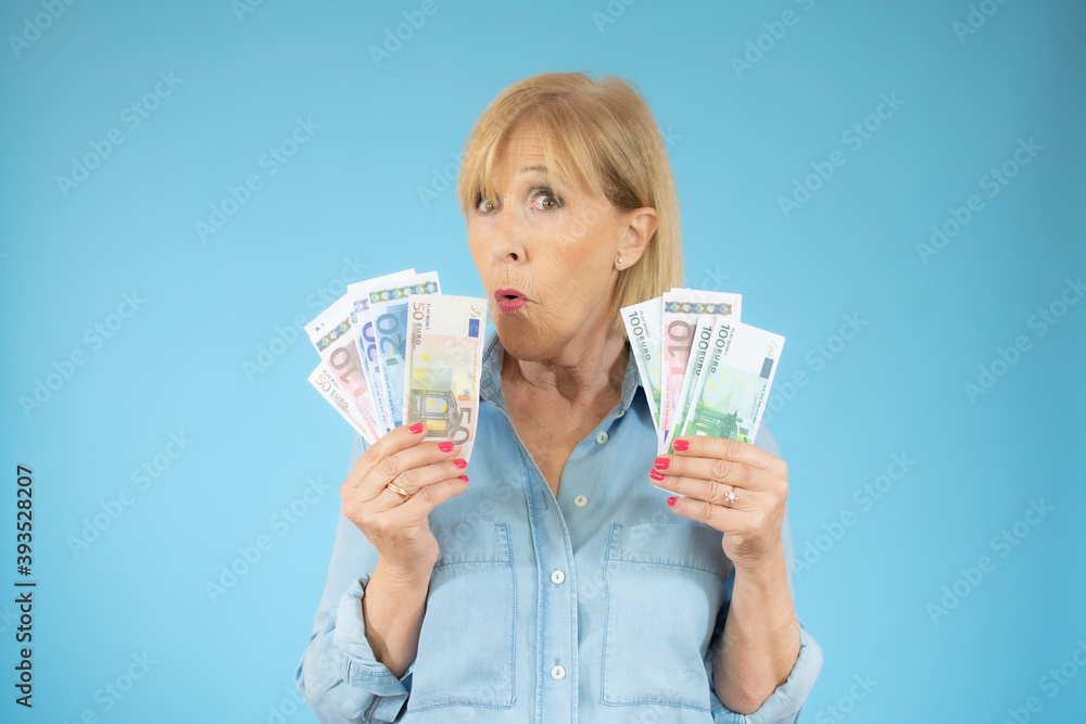 Savings, finances and people concept - smiling senior woman holding money banknotes Savings, finances and people concept - smiling senior woman holding money banknotes