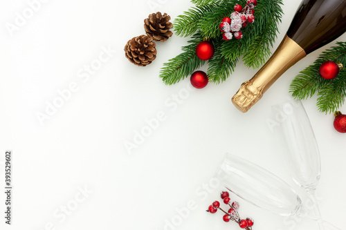 New Year decoration with champagne bottle and fir branches on white