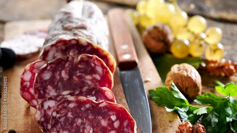 salami with grape and walnut on wooden board salami with grape and walnut on wooden board