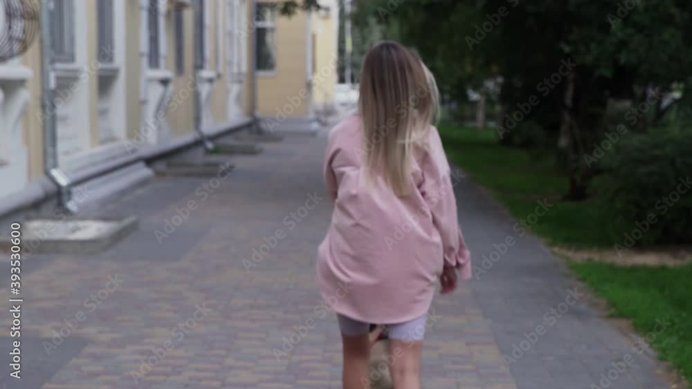 Woman wear face mask standing and looking at camera then leaving away with dog on a leash Woman wear face mask standing and looking at camera then leaving away with dog on a leash