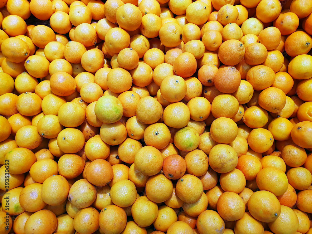 a lot of ripe orange oranges, orange background a lot of ripe orange oranges, orange background