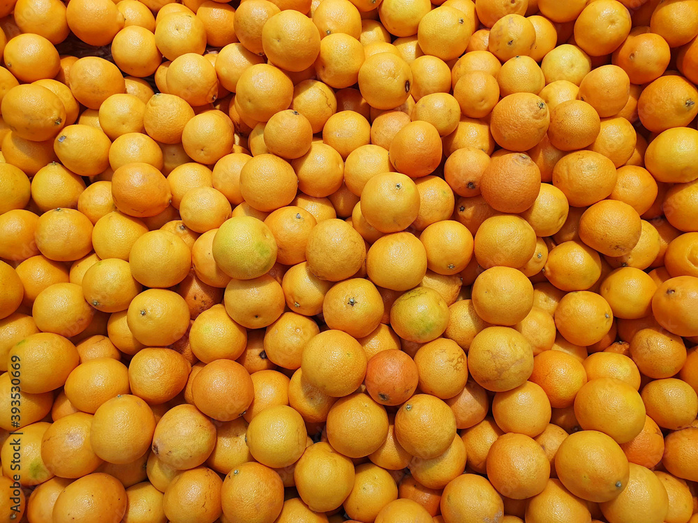 a lot of ripe orange oranges, orange background a lot of ripe orange oranges, orange background